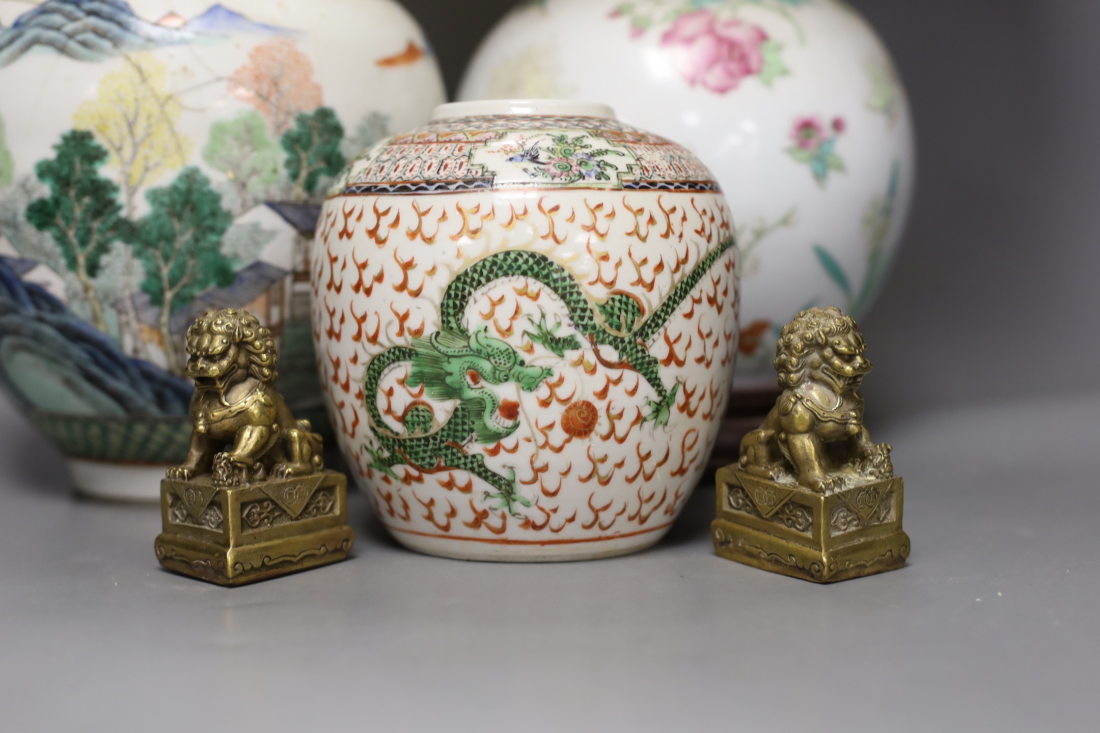 A Chinese table lamp, two Chinese Republic period enamelled porcelain jars, tallest 18.5 cm two brass lion dogs, lamp base 43 cm high (not including light fitting.)